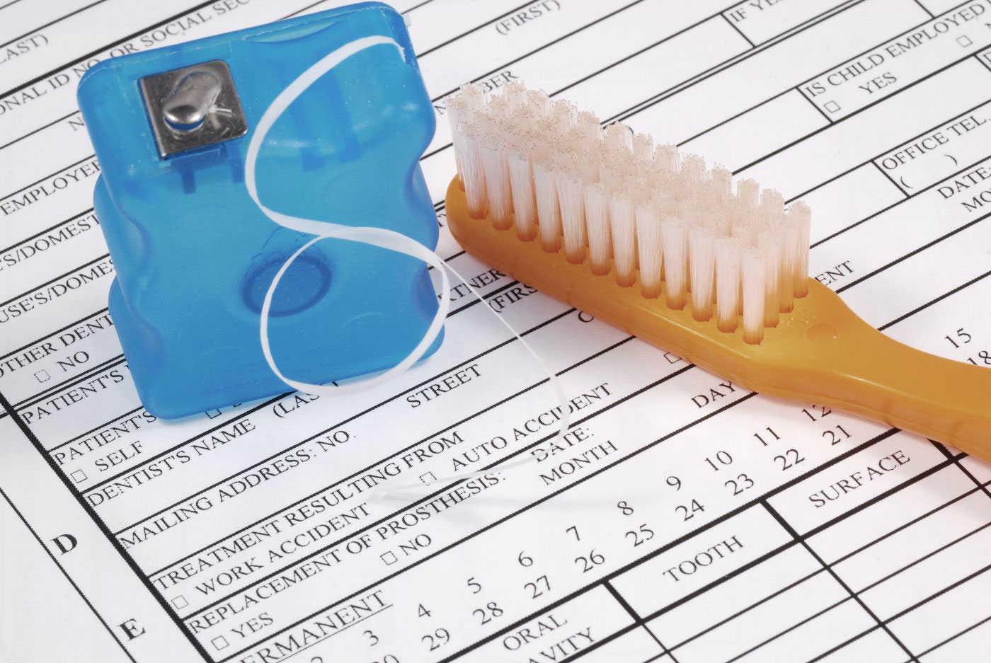 An image of a blue toothbrush with a small blue object and a white paper document containing text.