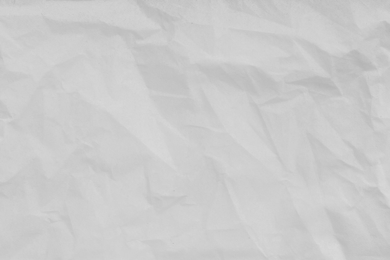 The image shows a crumpled piece of paper with a white background.