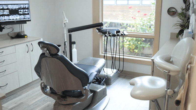 Dental chair with adjustable headrest in a dental office, ready for patient use.
